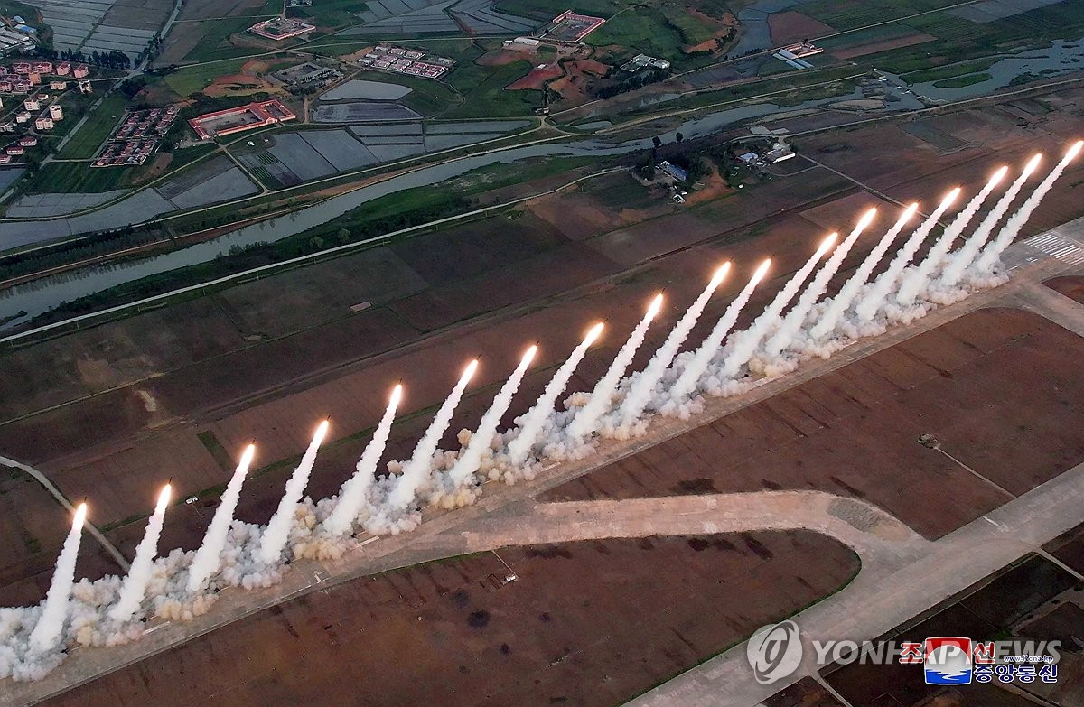 This file photo, carried by North Korea's official Korean Central News Agency on May 31, 2024, shows the North staging a firing drill involving 600 mm super-large multiple rocket launchers in a show of force the previous day, guided by North Korean leader Kim Jong-un. (For Use Only in the Republic of Korea. No Redistribution) (Yonhap)