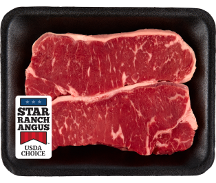 Two raw New York strip steaks in a package