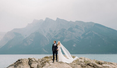 Bride and groom embracing in Banff, Alberta captured by Kaity Body Photography.