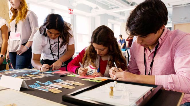 A group of students making notes together