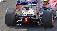 the rear of a Formula One car with a double decker diffuser located between the rear wheels