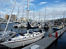 A north-to-east view from a boat slip in Marina del Rey's Basin E; Marina City Club is the left-most building, with the Ritz-Carlton Marina del Rey second from left. The photo depicts the original wood and canvas docks at Wayfarer Marina, which were replaced in 2019 by new concrete docks.