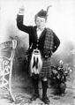 Boy wearing open necked velvet doublet, kilt and plaid (1898)