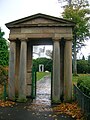 A portico surviving from the old Ibroxhill House which stood on this site. The 'Art Lover' house and the 'Giant Foot' artwork are in the background.