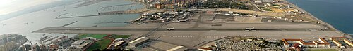 Composite image showing multiple stages of a Monarch Jet aircraft taking off from the Gibraltar Airport.