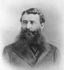 black-and-white 19th-century photo of a man with a bushy beard