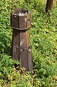 Small metal bollard adorned with stylized waves.