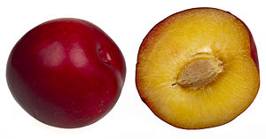 A plum whole and split