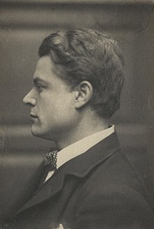 Black and white photograph of man's head and shoulders in side profile