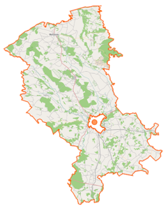 Mapa konturowa powiatu ostrołęckiego, blisko centrum u góry znajduje się punkt z opisem „Olsy Płoszyckie”