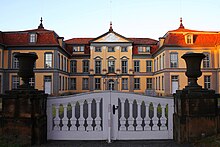 The symmetrical structure of Schloss Friedrichsthal, seen through the front gate to the property