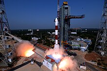 A PSLV-CA launch vehicle begins to lift off from its pad