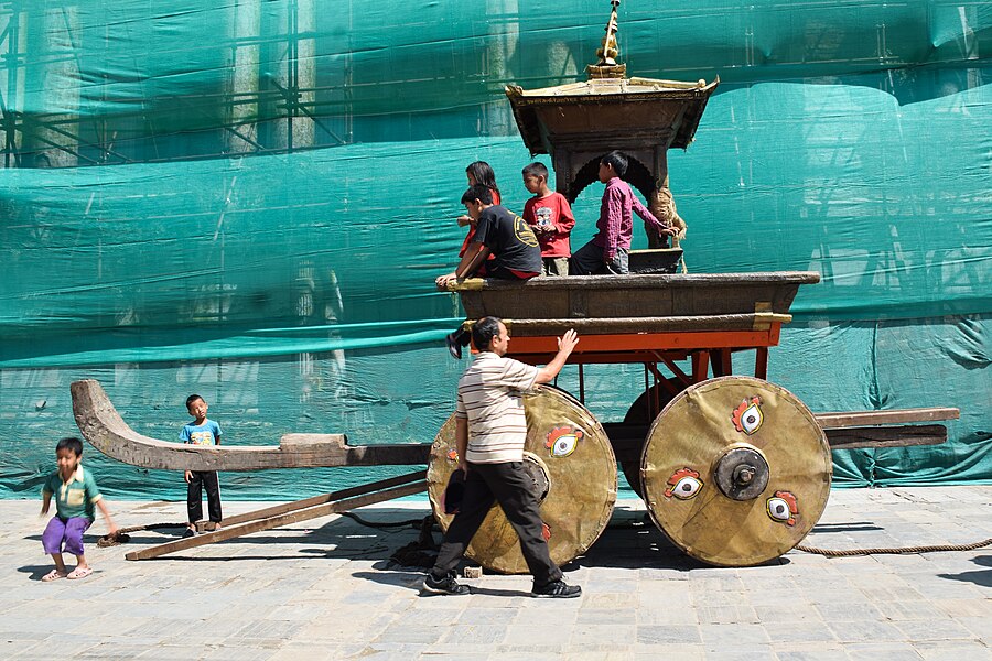 Nepal: The Chariot of Indra Jatra (a religious street festival) at Basantapur Durbar Square. The celebrations consist of two events. Indra Jātrā is marked by masked dances of deities and demons, displays of sacred images and tableaus in honor of the deity Indra, the king of heaven. The other event is Kumāri Jātrā, the chariot procession of the living goddess Kumari.