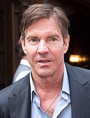 A shot of Dennis Quaid from his chest up, wearing a dress shirt and jacket.