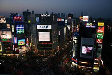 A moderately high view of a Shibuya intersection at night