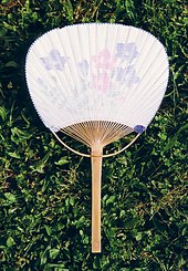 A white Eastern fan, with pink and purple flowers