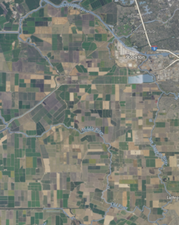 An aerial photograph of an island covered in farmland and surrounded by rivers.