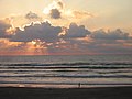 A person taking an early morning walk on the Gulf side of the island.