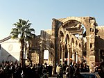 Ruins of a stone building with columns and without roof.