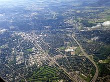 An aerial photograph of an urban area, with the Conestoga Parkway visible from the foreground into the distance