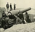 General Hazen's men of the Fifteenth Corps man a captured Confederate siege gun at Fort McAllister for the camera. Standing at attention above and facing the weapon is a U.S. Marine and beside him leaning on his saber is a cavalryman.