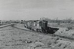 1958 train with many cars on curved track