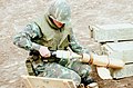 Fuzed 81 mm white phosphorus mortar shell in 1980. Note spelling of "fuze" on adjacent boxes