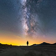 III La Voie lactée s'étendant au-dessus de la silhouette d'une femme, dans le désert des Mojaves , Californie.