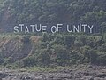 Statue of Unity sign board across the river.