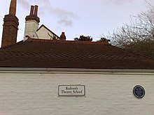 A sign displaying the name of Redroofs Theatre School.