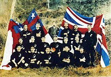 The 'native' rugby team in front of Te Kara and the Union Jack in 1889