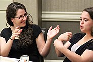 Photo of two women using sign language