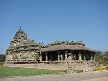 Exterior of a long, low temple against a blue sky