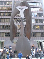 A large sculpture with kids climbing on it