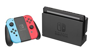 Eine Nintendo Switch im TV-Modus mit Joy-Cons in der Joy-Con-Halterung