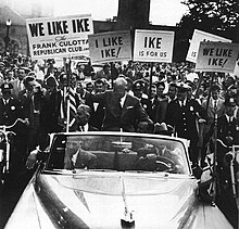 Eisenhower waves to supporters from an automobile