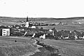 Blick von Norden über die ehemalige Stadt, mit der Stadtkirche Mariä Himmelfahrt. Im Hintergrund Reischdorf. Vor 1945.