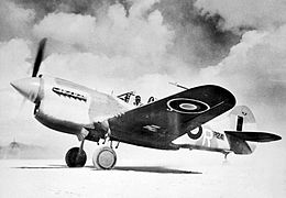 Single-engined military monoplane on desert airfield