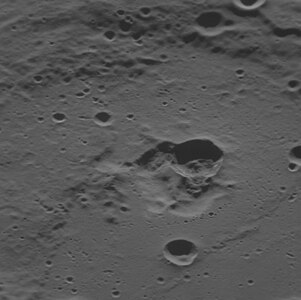 Oblique view facing west with the dark interior crater near center