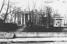 A large mansion. Polk's roofed tomb is seen on the right, near the street