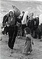 Palestinian woman, a child and a jug.