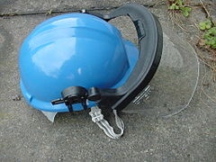 Workman's safety helmet with visor and chinstrap