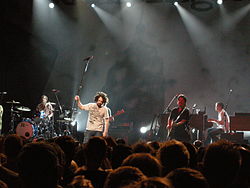 Counting Crows in Brussels, 2008. L to R: Bogios, Duritz, Immerglück, and Gillingham. Vickrey is cut off at the left, Powers is behind Duritz.