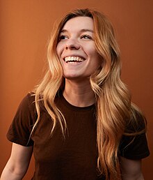 Headshot of Annie Rauwerda. She is a young woman with blond hair smiling.