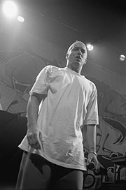 Eminem onstage in a white T-shirt