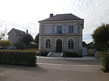 vue d'un bâtiment cubique ; inscription « mairie » gravée au-dessus de la porte