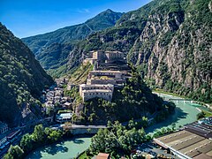 Photo shows a narrow valley and houses dominated by Fort Bard.