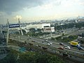 The cable-stayed bridge of Damansara–Puchong Expressway spanning over its intersection with Federal Highway in Petaling Jaya. Kuala Lumpur can be seen in the distant background on the right corner of the picture.