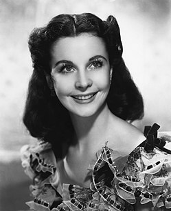 Vivien Leigh smiling as Scarlett O'Hara in a portrait setting.