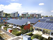 Short terraces of houses, with their entire sloping roofs covered with solar panels